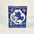 A Foo Dog graces the front and back panels of this rectangular square blue & white vase with a removable flower frog. The...