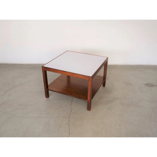 1960s two-tiered Midcentury Modern / American Modern walnut and white Formica coffee table was designed and stamped by...