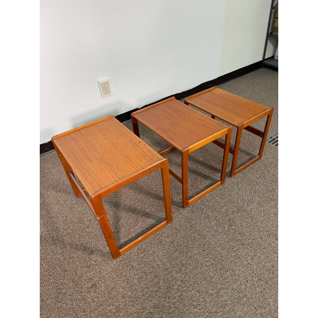 This piece is a mid century nesting table that has shown some age. The legs are marked up a little bit and one has a paint...