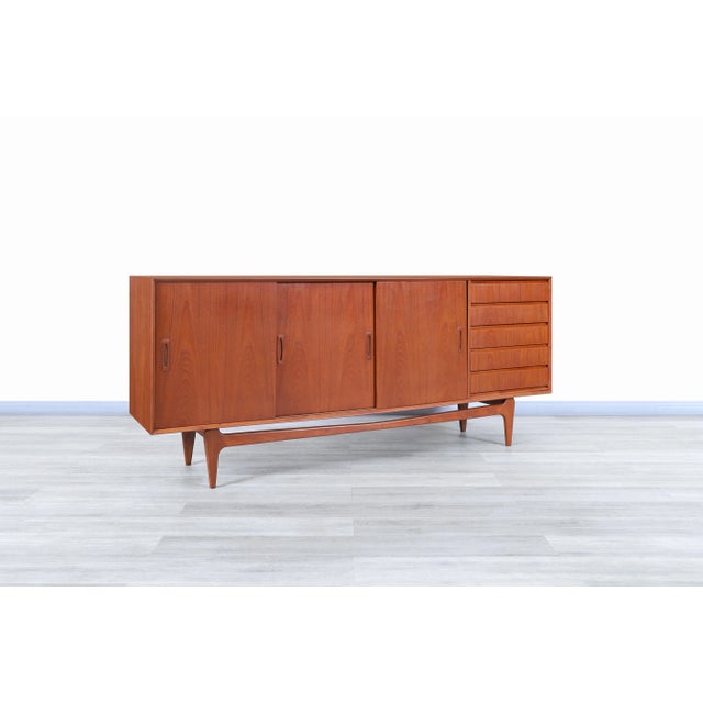 Fabulous Danish modern teak credenza designed and manufactured in Denmark, circa 1960s. This credenza has an elegant and...