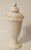 A tall vintage French lidded urn with a lovely creamy white glaze. This statement ceramic vessel is over 16" in height and...