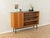 Classic sideboard from the 1950s. Walnut veneer body with one cabinet door, four shelves, and new square steel feet in...