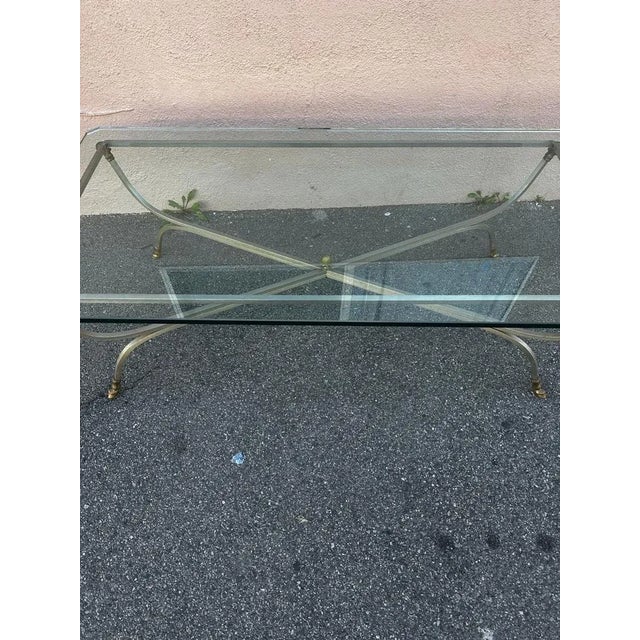 Neoclassical Jansen style rectangular style table designed with ram head cloven hoof. It comes with a class top fit for a...