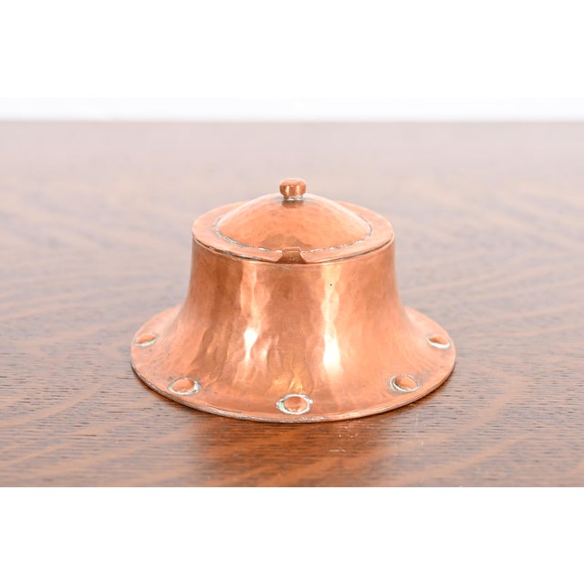 A gorgeous Arts & Crafts period hand hammered copper inkwell. By Roycroft (signed with impressed orb and cross mark) USA,...