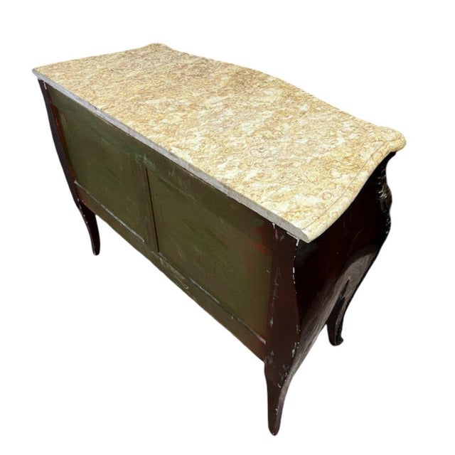 A curved, lacquered commode with japanese-style decoration opening front with two drawers without a central divider,...