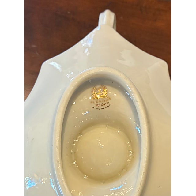 This is aLenox Holiday Dimension leaf shaped candleholder made of bone china. It is decorated with holly leaves and...