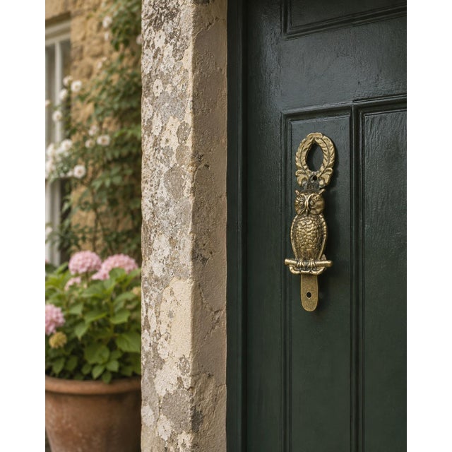 A charming mid-20th-century English door knocker cast in brass as a watchful owl perched upon a small branch. Textured...