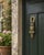 A charming mid-20th-century English door knocker cast in brass as a watchful owl perched upon a small branch. Textured...