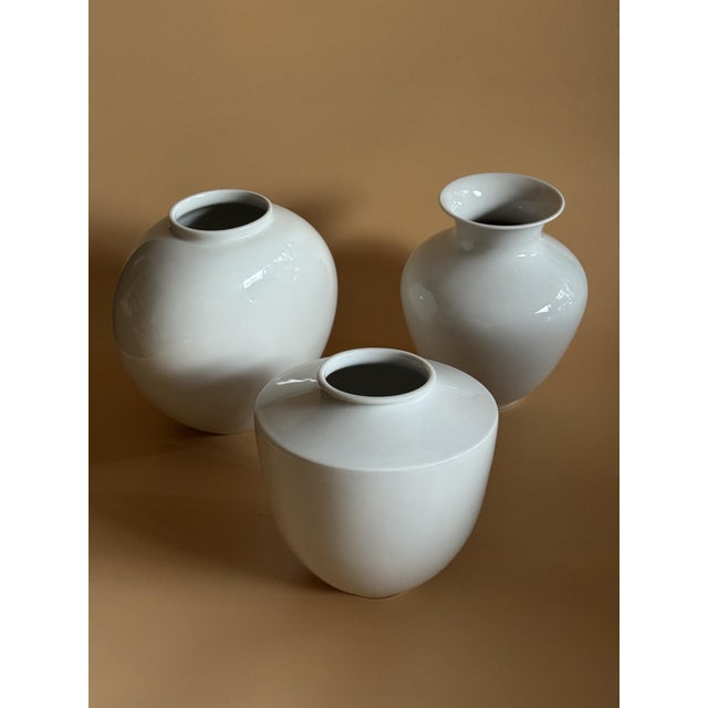 A rare triptych of white glazed porcelain vases dating back to 1925-1970 in berlin. the set consists of: two elegant and...