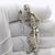 A rare and expressive piece of european thematic silverwork, this vintage figurine depicts a skilled handyman or...