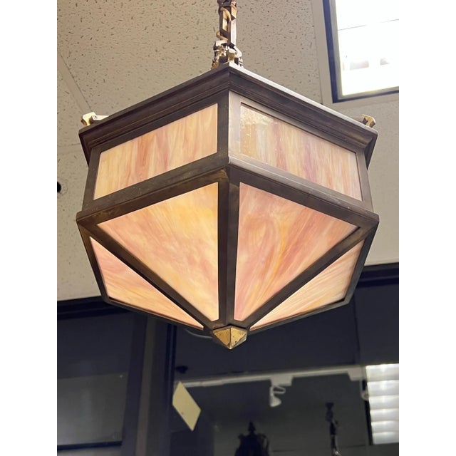 Very fine quality French hanging lamp in the Arts and Crafts style with hexagonal shape and slag glass in shades of pink....