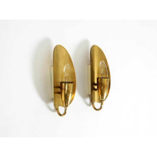 A paur of two beautiful, original mid-century modern brass cone wall lamps. Classic design from the golden era of the...