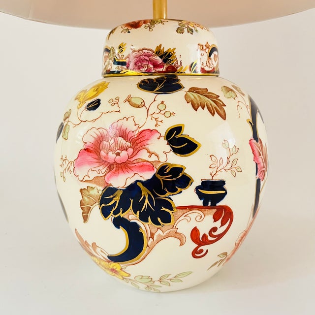 A mid 20th century round table lamp made from a highly detailed ironstone mason’s jar. Chinese inspired design, featuring...