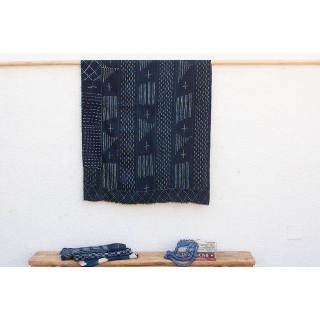 A masterwork of Malian textile heritage featuring deep indigo saturation and symbolic geometric motifs. Originating from...