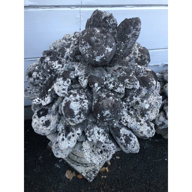 English cast stone, early 20C., garden ornament. Naturally aged, weathered patina. Floral, fruit-filled. Stands...