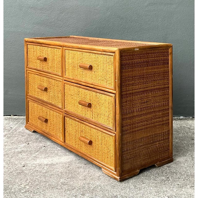 This vintage six-drawer dresser pairs a solid wood frame with tightly woven rattan panels, creating a warm, textural piece...
