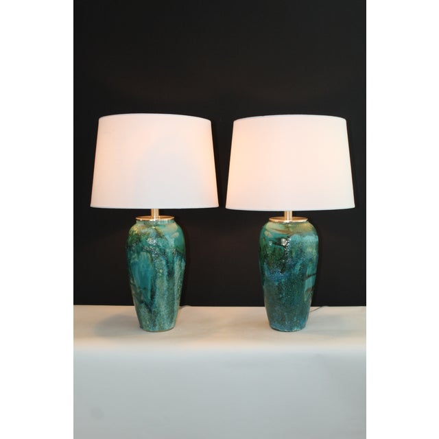A beautiful pair of Aldo Londi style. Unusual mottled glaze. Displaying a mix of vibrant colors .of jade, turquoise to...
