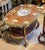 A magnificent French Louis XV-inspired coffee table crafted in rich wood and adorned with elaborate gilded details. Its...