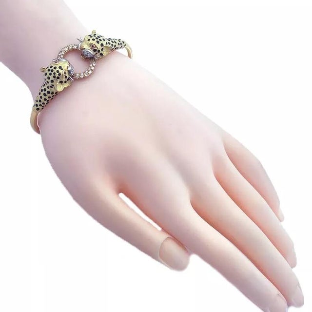 This is a classic style bracelet: it is crafted from 18k yellow gold featuring the door-knocker design with a double...