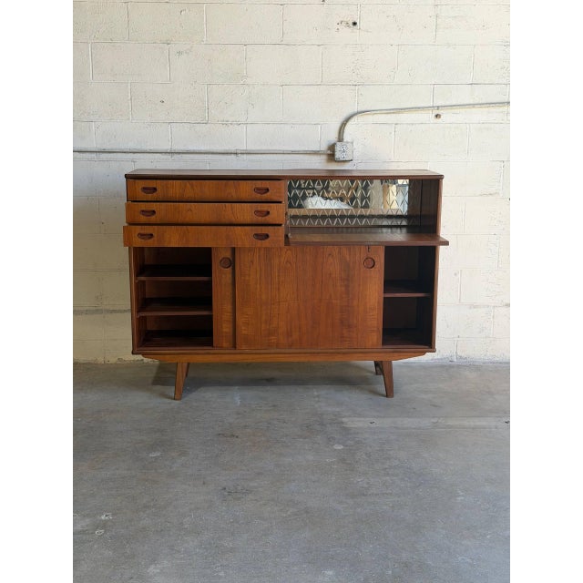Exceptional vintage Danish modern teak secretary cabinet from Denmark featuring a beautifully integrated drop-front...
