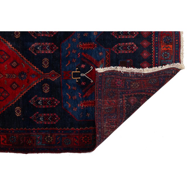 Elevate your space with this authentic vintage Shiraz runner rug, masterfully hand-knotted from soft, durable pure wool....