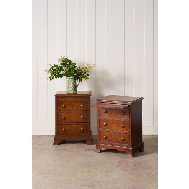 Pair of Georgian-style burl bedside chests, three drawers, brass bail pulls, and bracket feet.