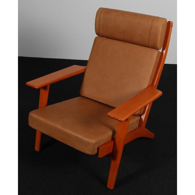 Hans j. Wegner lounge chair made of solid stained beech. New upholstered with vintage tan aniline leather. Model 290a,...