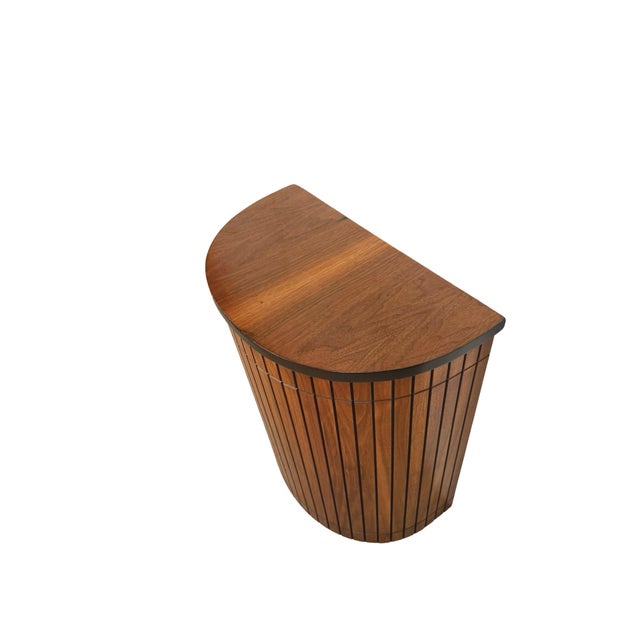 A beautifully sculptural vintage hamper with the clean geometry and warm wood character associated with Mid-Century Modern...