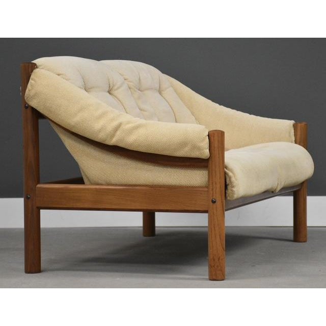 A mid century modern solid teak loveseat sofa with original off white fabric made by Domino Møbler. Minor inconspicuous...