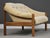 A mid century modern solid teak loveseat sofa with original off white fabric made by Domino Møbler. Minor inconspicuous...