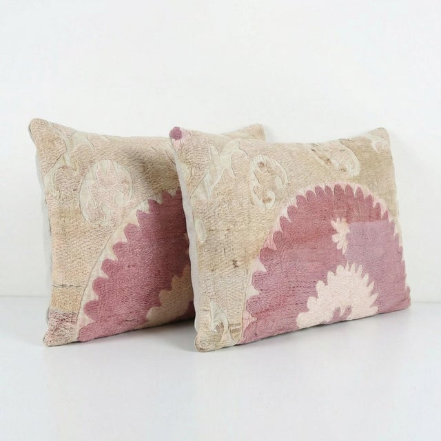 This beautiful 14'' x 22'' hand-embroidered Suzani pillow cover set was made from authentic Uzbek cotton fabric. The...