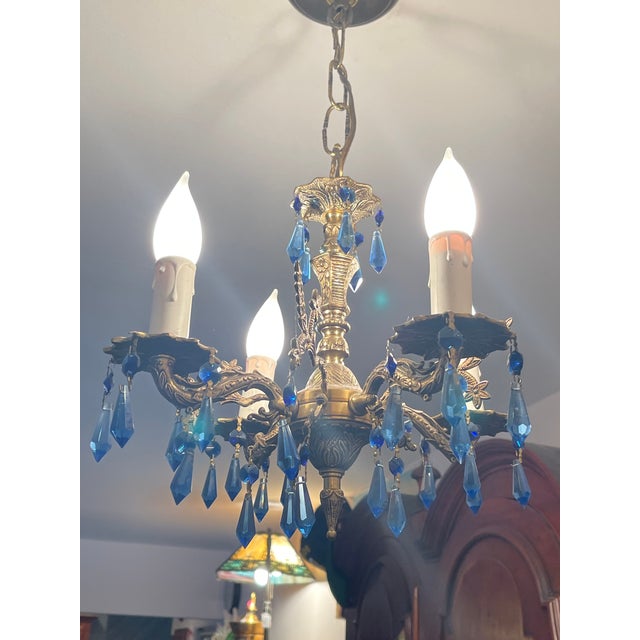 Fabulous small ornate bronze pendant chandelier with cut blue crystals. Unique design.