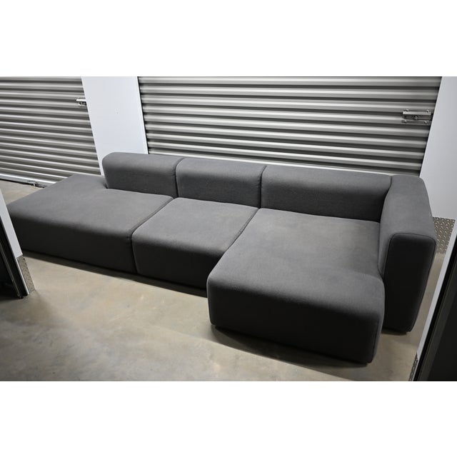 Hay Mags Low Sectional, 1 arm wide with chaise, right orientation, 3 sections. Charcoal Mode fabric upholstery. The center...