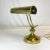 This style of lamp is referred to as a Piano Lamp because it would sit on the piano above the sheet music giving it light...