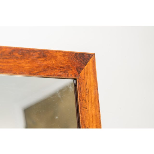 Danish mirror from the 60s with a beautiful rectangular wooden frame measuring 122 x 63 centimeters.