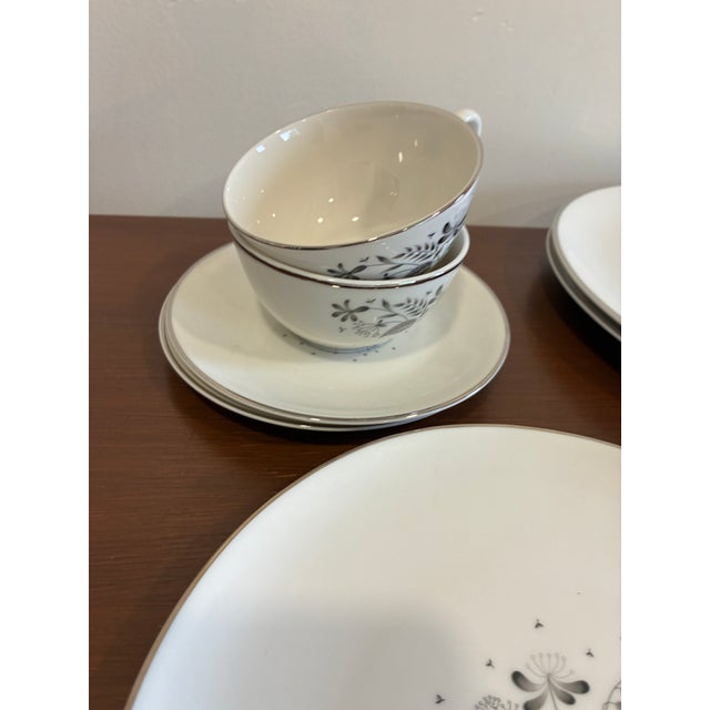 This elegant Royal Jackson “Parisienne” dinnerware set showcases a refined black botanical motif accented with subtle...