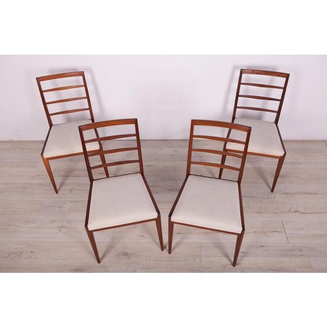 Set of four dining chairs produced by McIntosh in the United Kingdom circa 1960. The frames are made of teak and the seats...