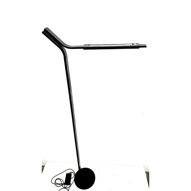 "Sovrana" floor lamp by designer Bruno Gecchelin for Oluce, produced in 1977. Black painted metal and plastic parts in the...