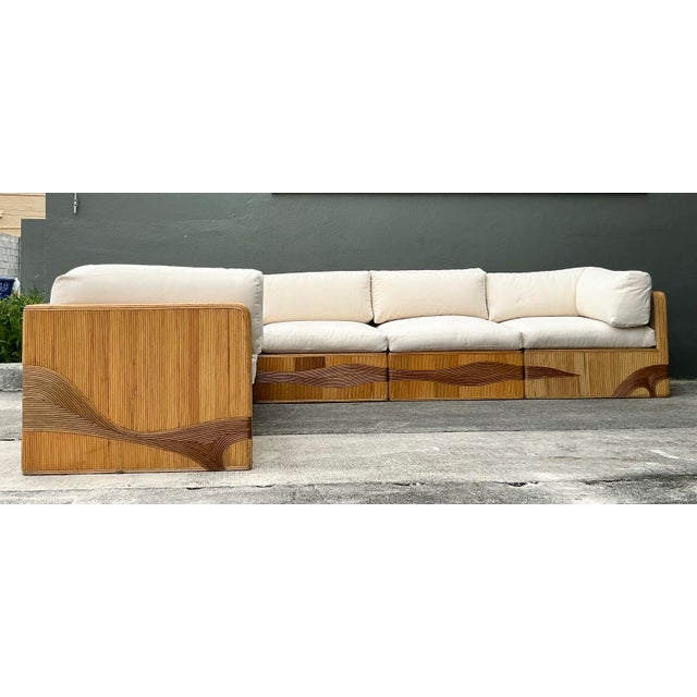 Transform your living space into a coastal sanctuary with this magnificent vintage pencil reed modular sectional. This...