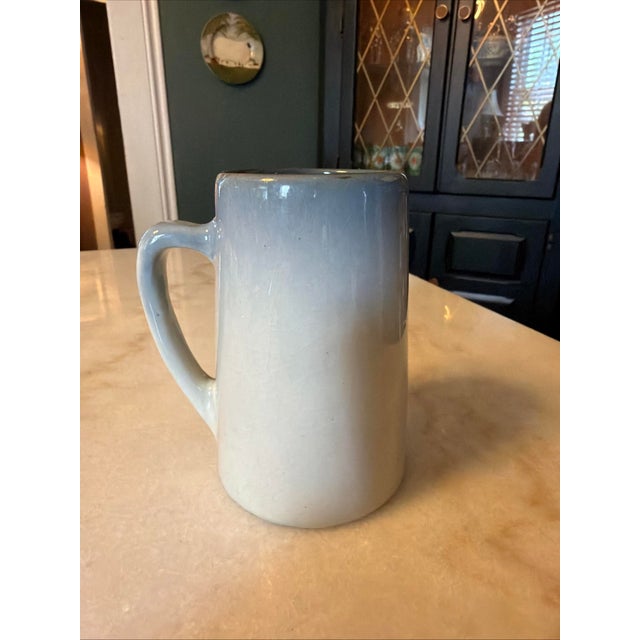 The Antique WELLER POTTERY "ETNA" Hand-Painted Mug/Tankard from around 1906 is a charming vintage piece with a floral...
