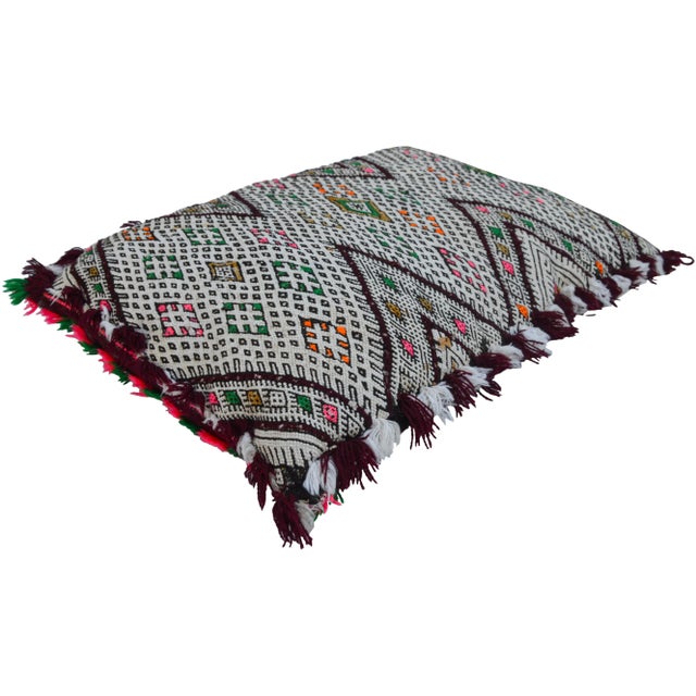 One-of-a-kind Moroccan pillow handwoven by the Berbers of the High Atlas Mountains. Features an ornate striped design...