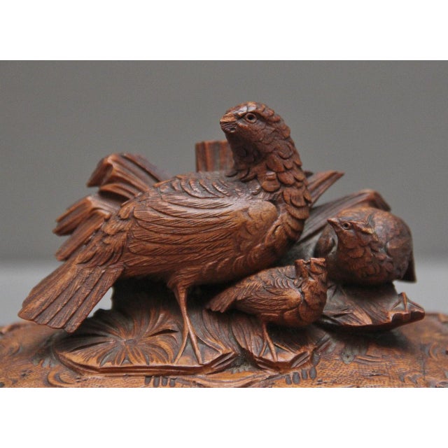 A good quality 19th Century black forest walnut casket, having wonderful crisp carving throughout, the hinged top lifting...