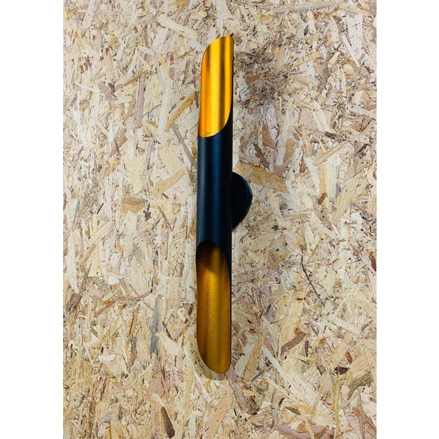 70s Italian Wall Sconce – Matte Black and Gold Elegant modern Italian style wall sconce, made in Italy in the 70s. This...