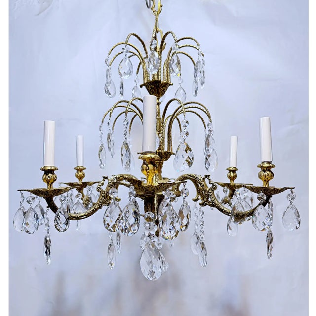This is a Spanish style bronze chandelier with ornate designed frame and dressed with Swedish style hand cut crystal. It...