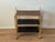 Vintage three-tier bar cart featuring a gold-tone metal frame, smoked plastic shelves.