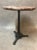 Pedestal bistro, pink marble top and cast iron base. Manque strapping around the original marble