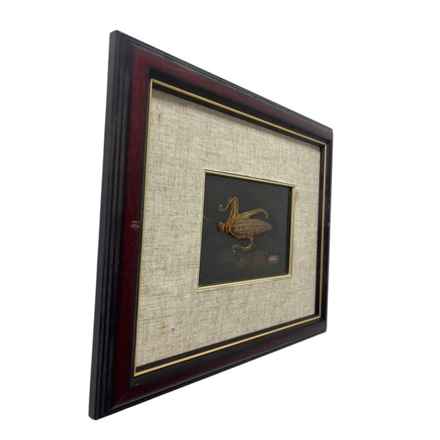 This framed relief is attributed to Eriko, described in the supplied artist information as an experienced Japanese shippo...