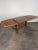 Beautifully grained mid century Danish modern teak expanding dining table with two hide-a-way leafs. (Refinished). The...