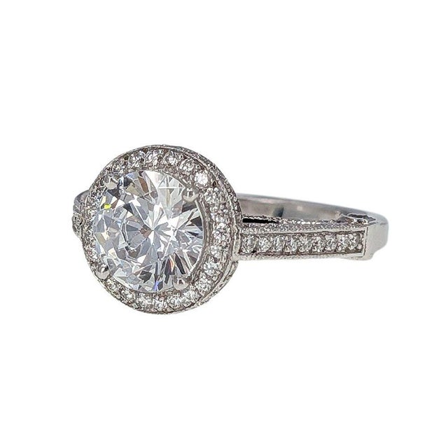 Estate Stardust 18KW Halo Engagement Ring with CZ center. This estate halo engagement ring is crafted in 18 karat white...