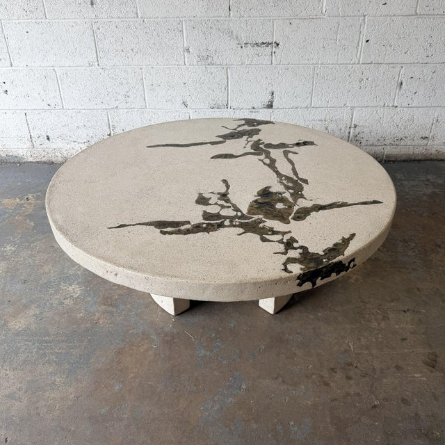 A sculptural Terra coffee table by Silas Seandel, combining cast concrete with the embedded bronze detail that makes this...
